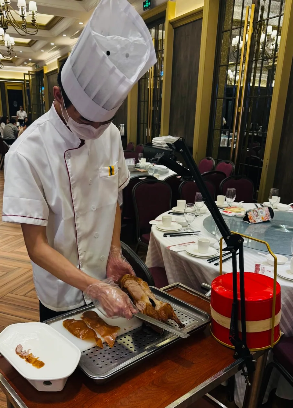 Tableside duck carving in an elegant dining room
