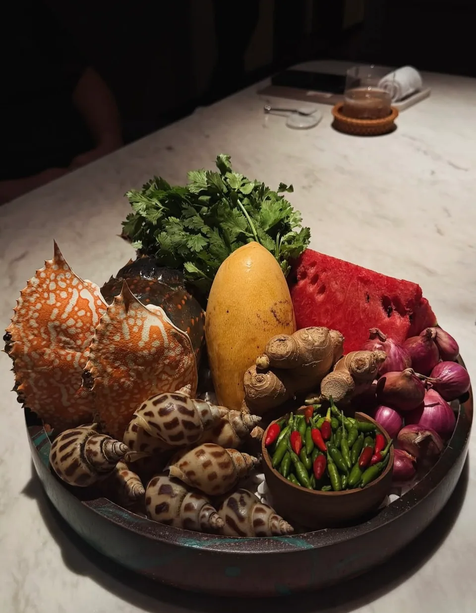 A tray of fresh seafood, herbs, vegetables and fruit